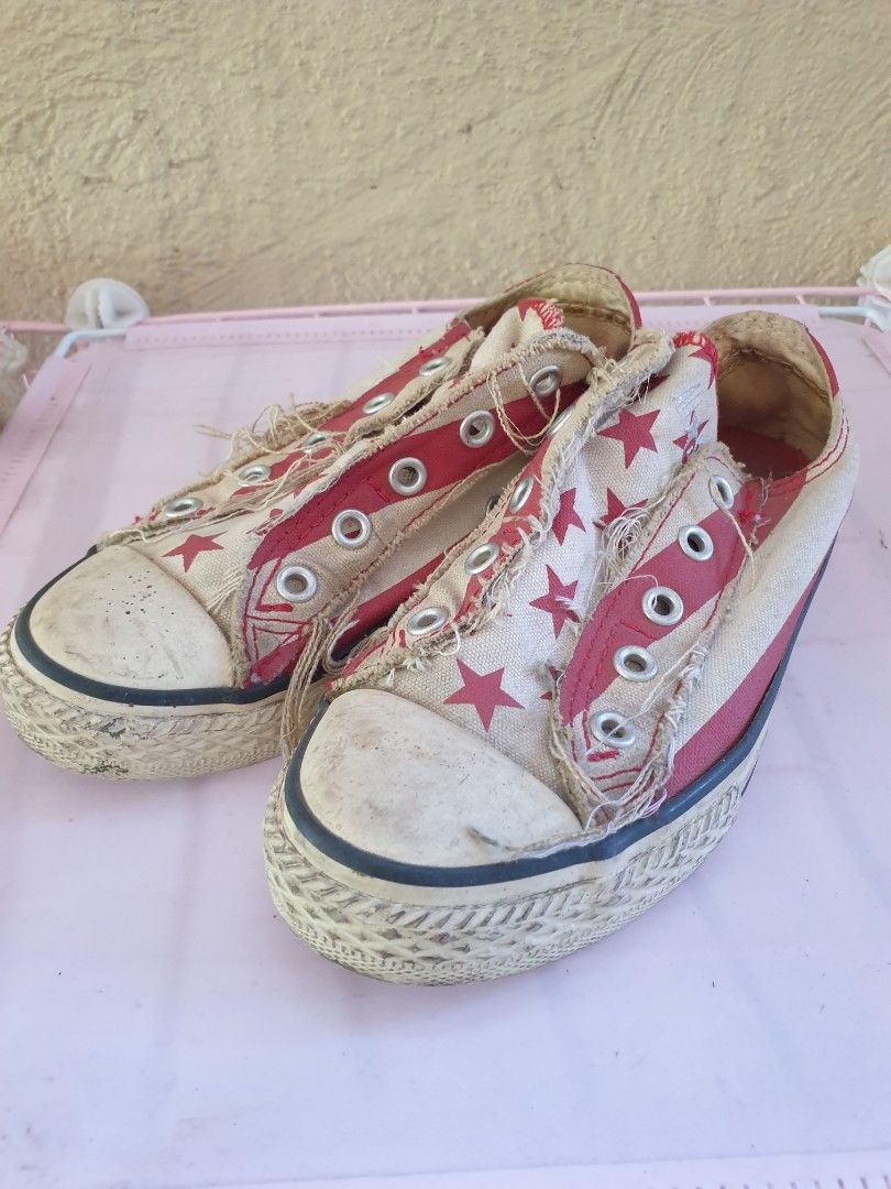 Converse All Star red star print sneakers (Category: Babies & Kids Fashion) located in Las Pinas. Submitted by anggesmart (Listing ID 1468383587, Image 1). Description: - Brand: Converse All Star - Style: Low-top canvas sneakers - Color/Design: Red and white with an all-over star pattern - Details: Trendy frayed raw edges along the lace panels and classic rubber toe caps - Condition: Pre-loved with scuffs and dirt on the soles; standard diamond t