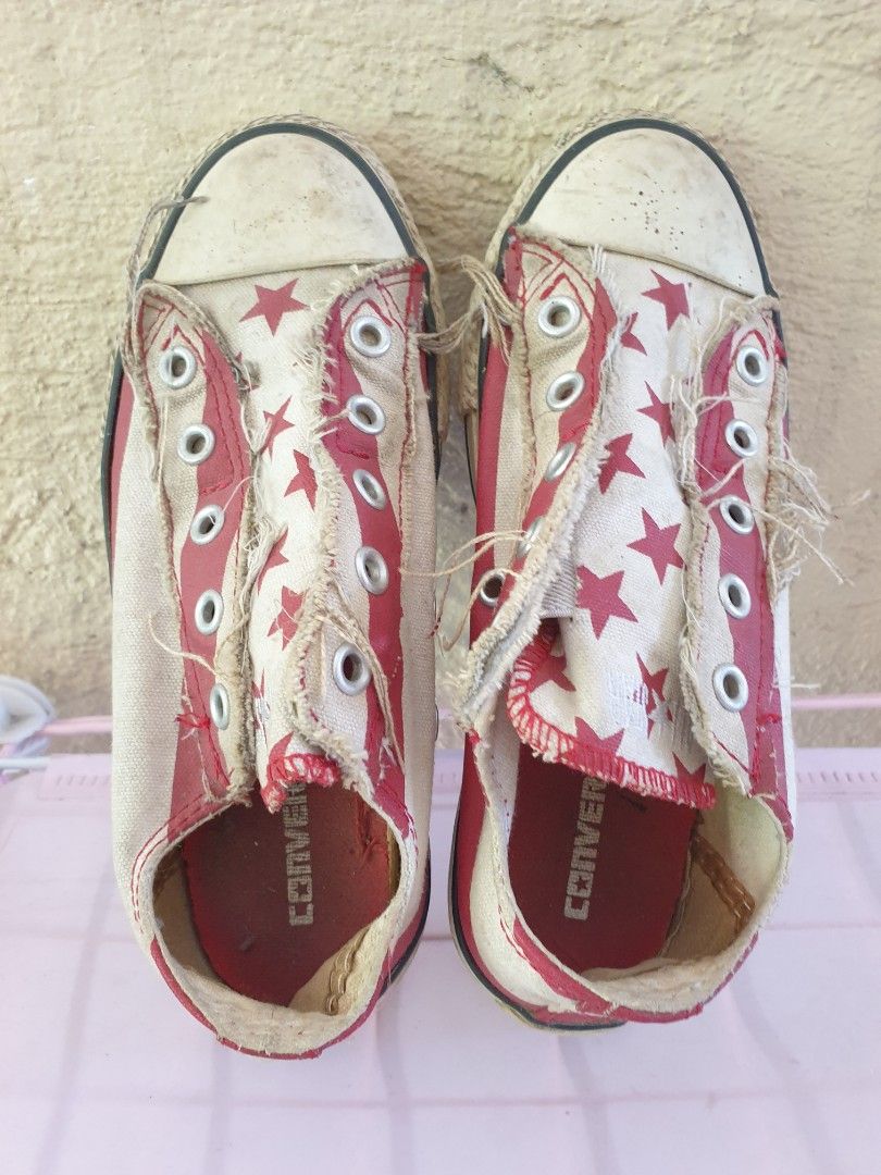 Converse All Star red star print sneakers (Category: Babies & Kids Fashion) located in Las Pinas. Submitted by anggesmart (Listing ID 1468383587, Image 2). Description: - Brand: Converse All Star - Style: Low-top canvas sneakers - Color/Design: Red and white with an all-over star pattern - Details: Trendy frayed raw edges along the lace panels and classic rubber toe caps - Condition: Pre-loved with scuffs and dirt on the soles; standard diamond t