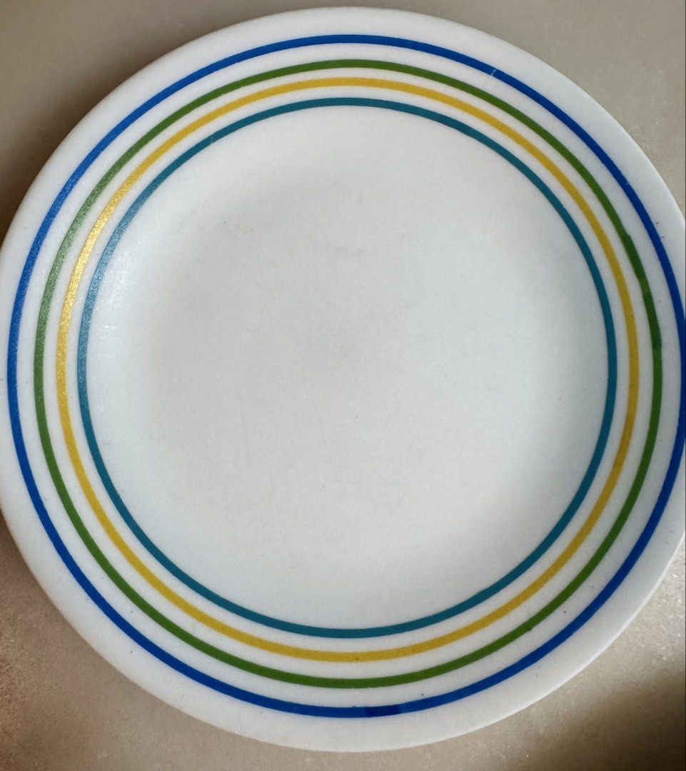 Corelle dinnerware 12 pc set (Category: Dinnerware & Cutlery) located in Paranaque City. Submitted by tripleddd151025 (Listing ID 1468299566, Image 1). Description: 4 pcs dinner plate 4 pcs dessert plate 4 pcs serving bowl - Set includes white ceramic plates and a bowl with colorful blue, green, and yellow rings - Classic and simple design, perfect for daily meals and hosting guests - Smooth and easy-to-clean glossy finish - Microwave and dishwas