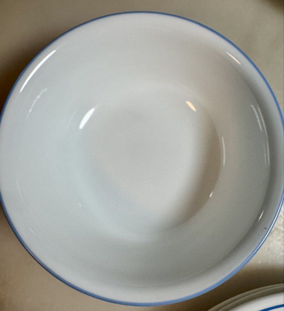 Corelle dinnerware 12 pc set (Category: Dinnerware & Cutlery) located in Paranaque City. Submitted by tripleddd151025 (Listing ID 1468299566, Image 3). Description: 4 pcs dinner plate 4 pcs dessert plate 4 pcs serving bowl - Set includes white ceramic plates and a bowl with colorful blue, green, and yellow rings - Classic and simple design, perfect for daily meals and hosting guests - Smooth and easy-to-clean glossy finish - Microwave and dishwas