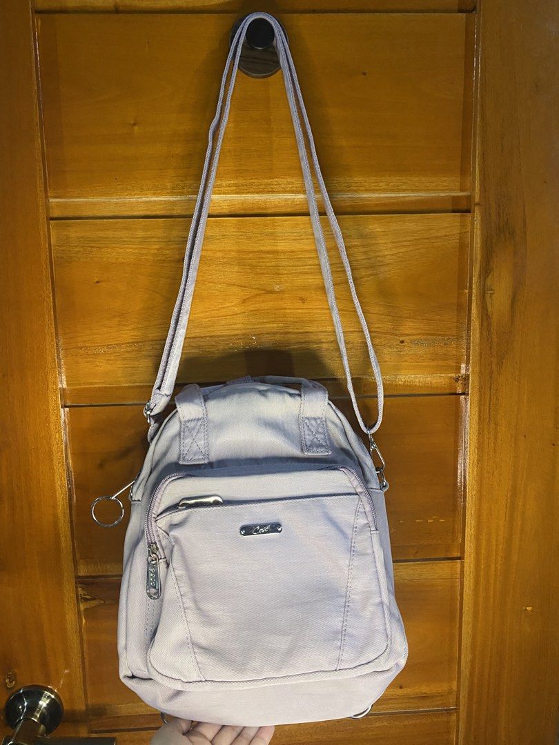 Cosé Purple Convertible Backpack Shoulder Bag (Category: Backpacks) located in Baguio. Submitted by heath2600 (Listing ID 1468437247, Image 3). Description: - Brand/Style: Cosé canvas shoulder bag and mini backpack - Color: Muted purple shade - Hardware: Silver-tone with handy side ring attachment - Pockets: Convenient front zip pockets - Handles/Straps: Top grab handles plus an adjustable and removable strap - Condition: Clean fabric interior an