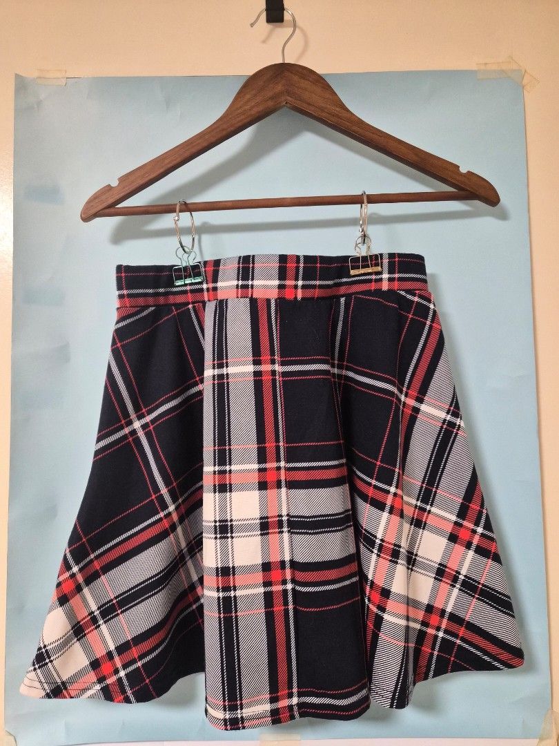 Cotton On Plaid Skirt Size L (Category: Skirts) located in Manila. Submitted by prelovedbyc.hannah (Listing ID 1468430583, Image 2). Description: - Brand: Cotton On - Size: L (Tag attached inside) - Design: Red, black, and white plaid with pleated details and a structured waistline - Material: Soft and comfortable fabric (Made in China) - Styling: Easy to match with basic tees or cozy oversized sweaters for a casual look.