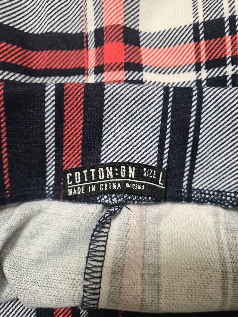 Cotton On Plaid Skirt Size L (Category: Skirts) located in Manila. Submitted by prelovedbyc.hannah (Listing ID 1468430583, Image 3). Description: - Brand: Cotton On - Size: L (Tag attached inside) - Design: Red, black, and white plaid with pleated details and a structured waistline - Material: Soft and comfortable fabric (Made in China) - Styling: Easy to match with basic tees or cozy oversized sweaters for a casual look.