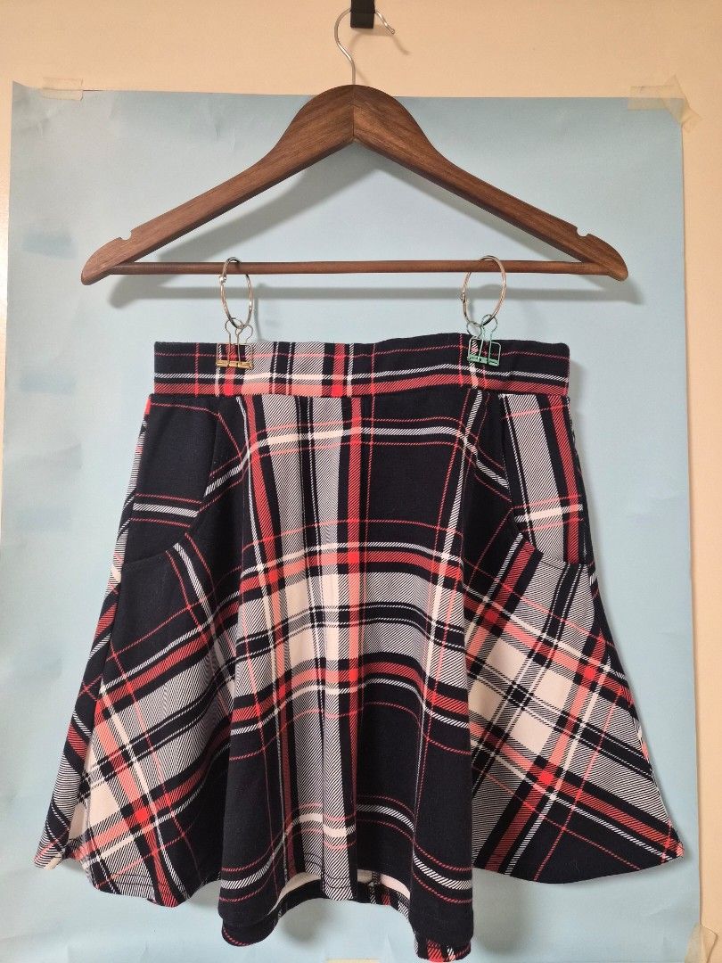 Cotton On Plaid Skirt Size L (Category: Skirts) located in Manila. Submitted by prelovedbyc.hannah (Listing ID 1468430583, Image 1). Description: - Brand: Cotton On - Size: L (Tag attached inside) - Design: Red, black, and white plaid with pleated details and a structured waistline - Material: Soft and comfortable fabric (Made in China) - Styling: Easy to match with basic tees or cozy oversized sweaters for a casual look.