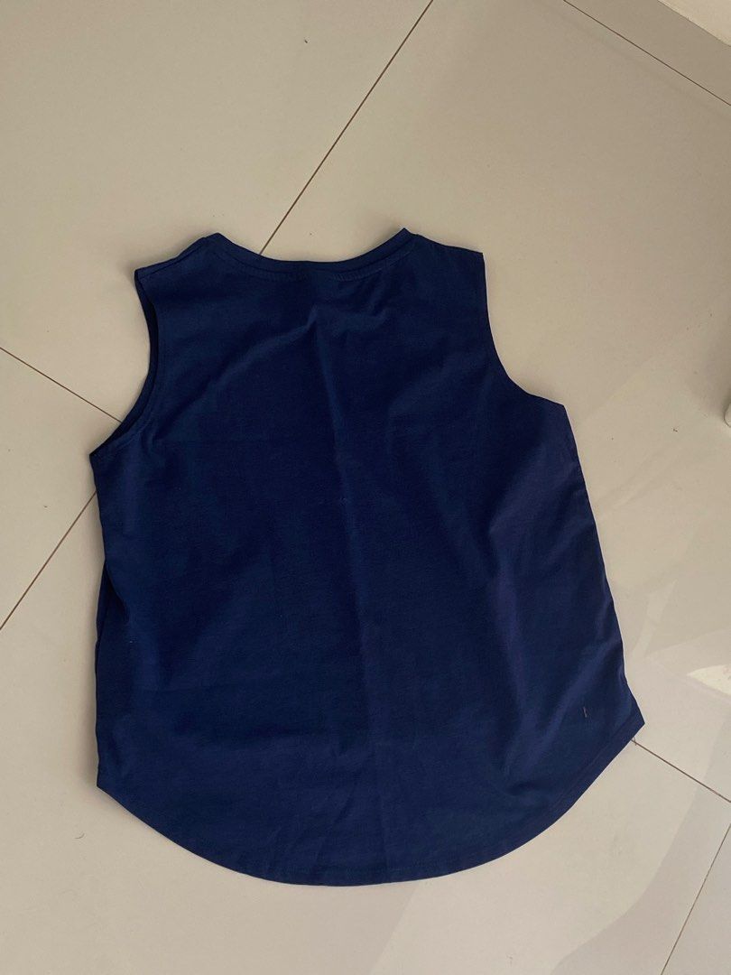 Cotton Tree Navy Blue Tank Top (Category: Sleeveless) located in Manila. Submitted by tonialalelilolu (Listing ID 1468333138, Image 3). Description: - Brand: Cotton Tree - Color: Navy Blue - Style: Sleeveless top with round neckline - Design: Curved hemline, slightly longer at the back - Material: Lightweight and breathable - Ideal for: Casual days or workouts - Condition: Excellent, no stains or tears.