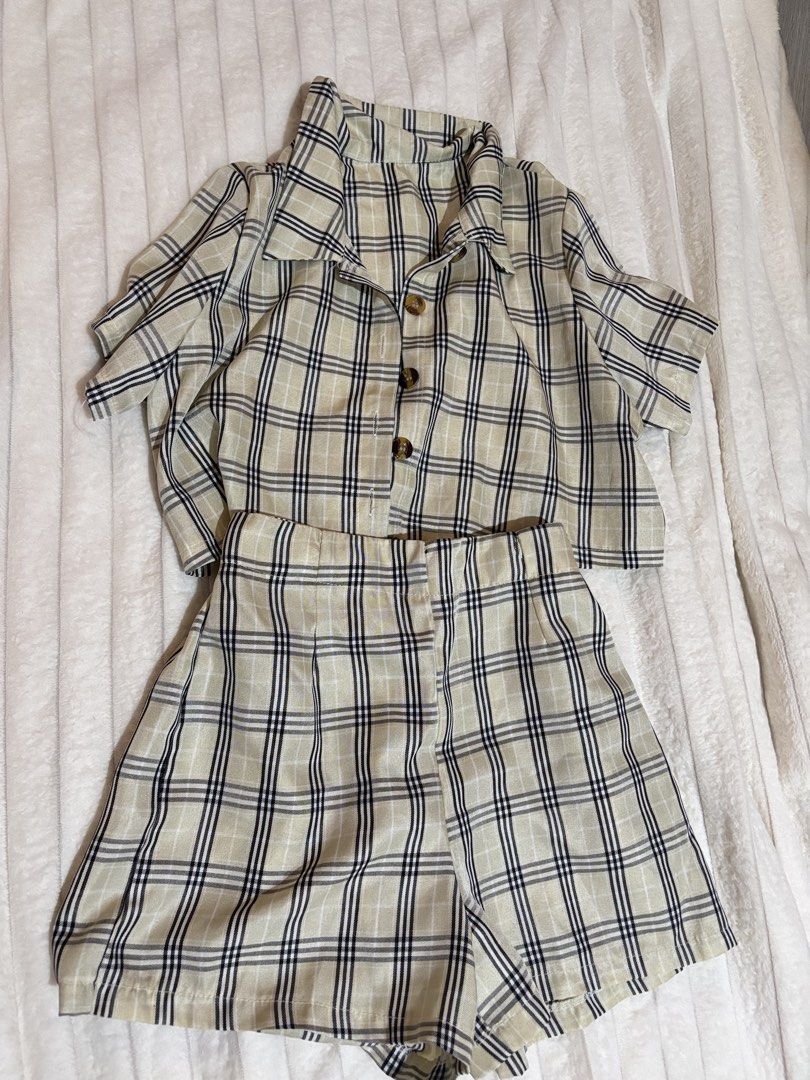 Cream and Black Plaid Two-Piece Shorts Set (Category: Sets or Coordinates) located in Quezon City. Submitted by hadescloset (Listing ID 1468394571, Image 1). Description: - Style: Matching short sleeve button-down top and high-waisted shorts set - Print/Color: Cream background with black and white plaid pattern, plus brown front buttons - Material: Lightweight and breathable, perfect for warm weather - Condition: Excellent, worn only a couple of 