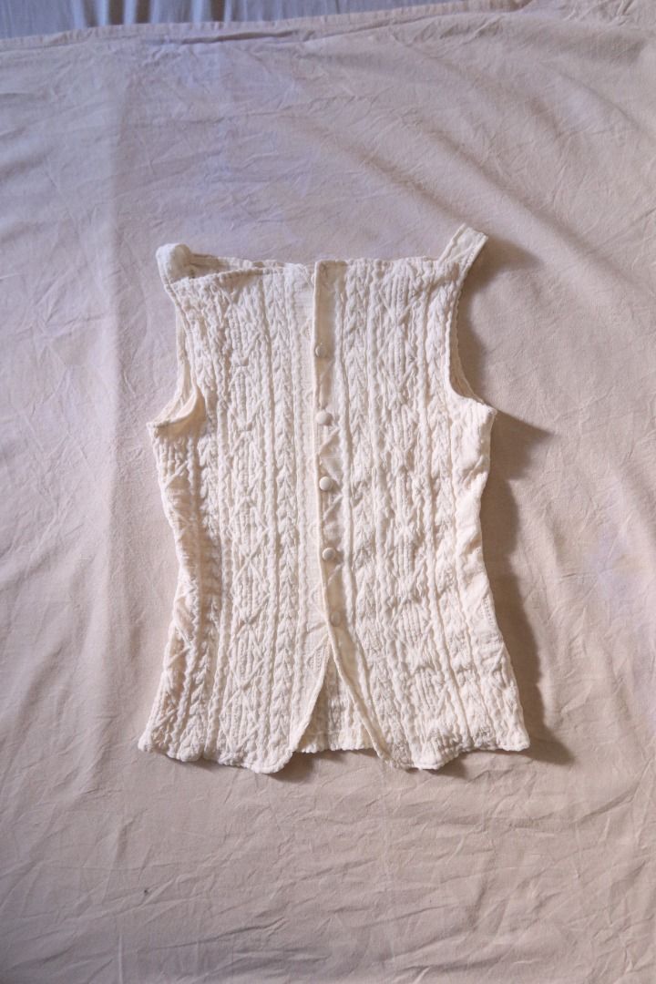Cream cable knit sleeveless button-down top (Category: Sleeveless) located in Manila. Submitted by imama23 (Listing ID 1468351612, Image 1). Description: - Color: Cream - Style: Sleeveless knit top with square neckline - Condition: Like new, never used Location: Manila MOP: GCASH, Bank Transfer Shipping to be shouldered by buyer.