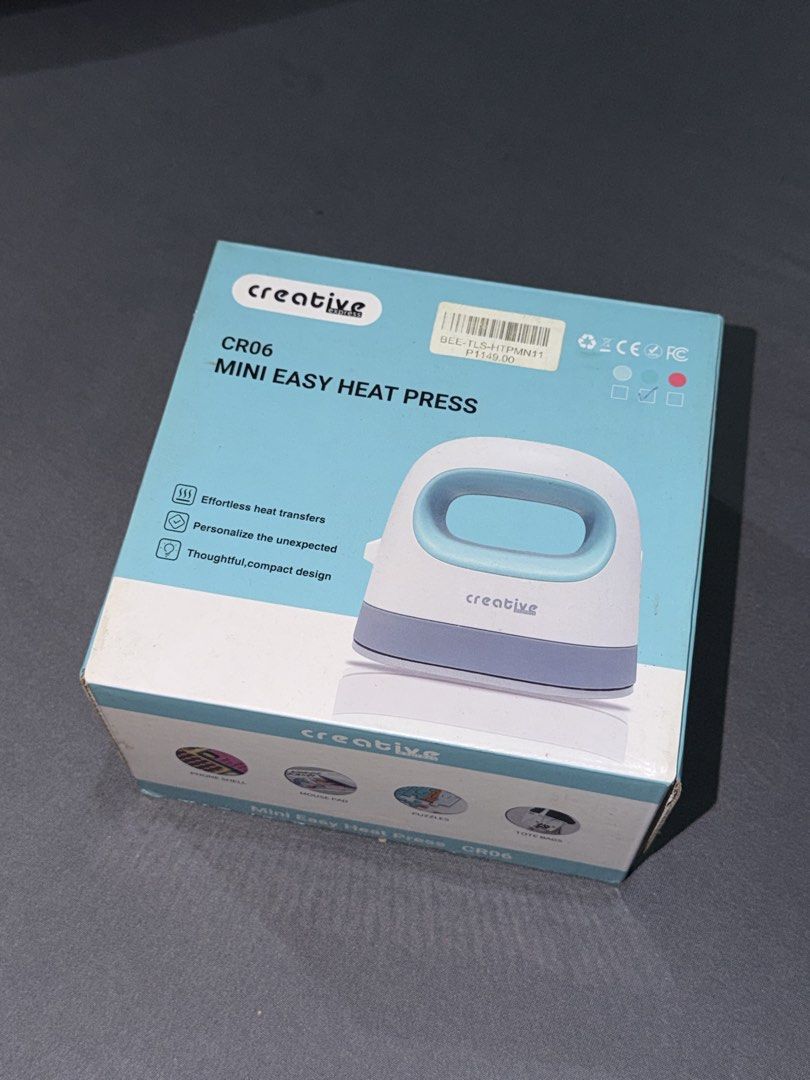 Creative Express CR06 Mini Easy Heat Press (Category: Craft Supplies & Tools) located in Quezon City. Submitted by jpfinds (Listing ID 1468435654, Image 2). Description: - Model: Creative Express CR06 Mini Easy Heat Press - Color: White and Teal - Ideal for: Small DIY craft projects such as custom shirts, hats, and tote bags - Features: Compact size, fast heat-up, and easy vinyl transfers - Inclusions: Original safety base and complete box packag