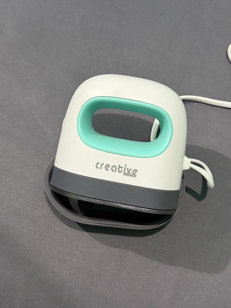 Creative Express CR06 Mini Easy Heat Press (Category: Craft Supplies & Tools) located in Quezon City. Submitted by jpfinds (Listing ID 1468435654, Image 3). Description: - Model: Creative Express CR06 Mini Easy Heat Press - Color: White and Teal - Ideal for: Small DIY craft projects such as custom shirts, hats, and tote bags - Features: Compact size, fast heat-up, and easy vinyl transfers - Inclusions: Original safety base and complete box packag
