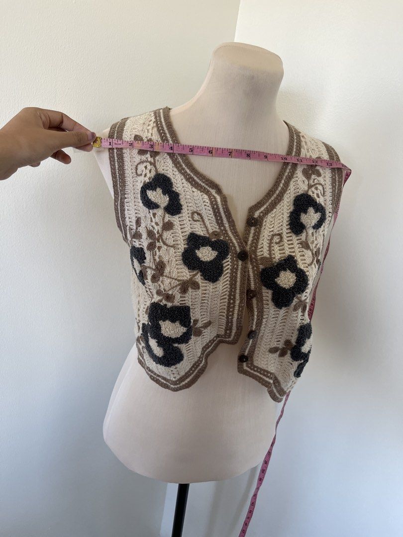 Crochet Floral Pattern Button-Up Crop Vest (Category: Sleeveless) located in Mandaluyong City. Submitted by bravedeer.020ad7 (Listing ID 1468365265, Image 2). Description: - Style: Crochet crop vest with cute scalloped hem - Colors: Cream with dark grey floral motifs and brown contrast trim - Closure: Front button-up design with brown buttons - Measurements: Chest width ~13 inches across, Total length ~14 inches from shoulder - Condition/Use: Exc