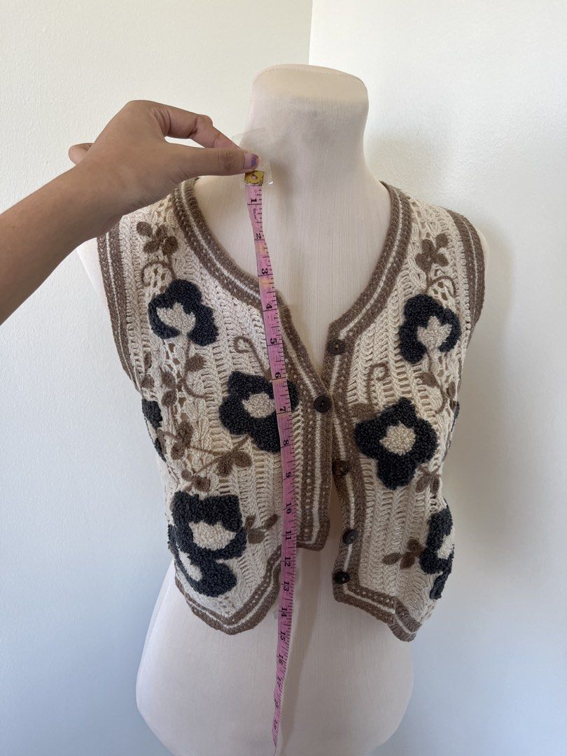 Crochet Floral Pattern Button-Up Crop Vest (Category: Sleeveless) located in Mandaluyong City. Submitted by bravedeer.020ad7 (Listing ID 1468365265, Image 3). Description: - Style: Crochet crop vest with cute scalloped hem - Colors: Cream with dark grey floral motifs and brown contrast trim - Closure: Front button-up design with brown buttons - Measurements: Chest width ~13 inches across, Total length ~14 inches from shoulder - Condition/Use: Exc
