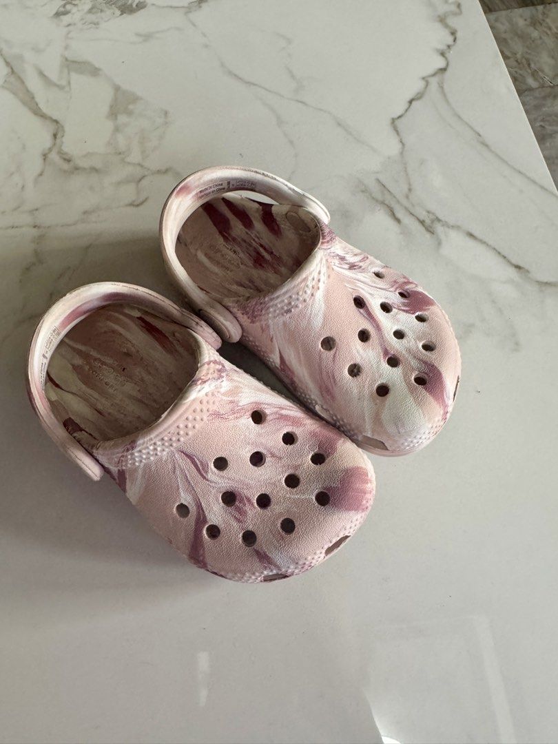 Crocs Classic Marbled Clogs Pink White Size C6 (Category: Babies & Kids Fashion) located in Pasig City. Submitted by gaylepacs (Listing ID 1468284394, Image 1). Description: - Item: Pink and white marbled Crocs clogs - Size: C6 - Condition: Moderate wear on bottom treads with some staining underneath, still has plenty of life left - Best for: Everyday wear, playground trips, and casual outings RFS: Outgrown Shipping c/o buyer Location: Pasig.