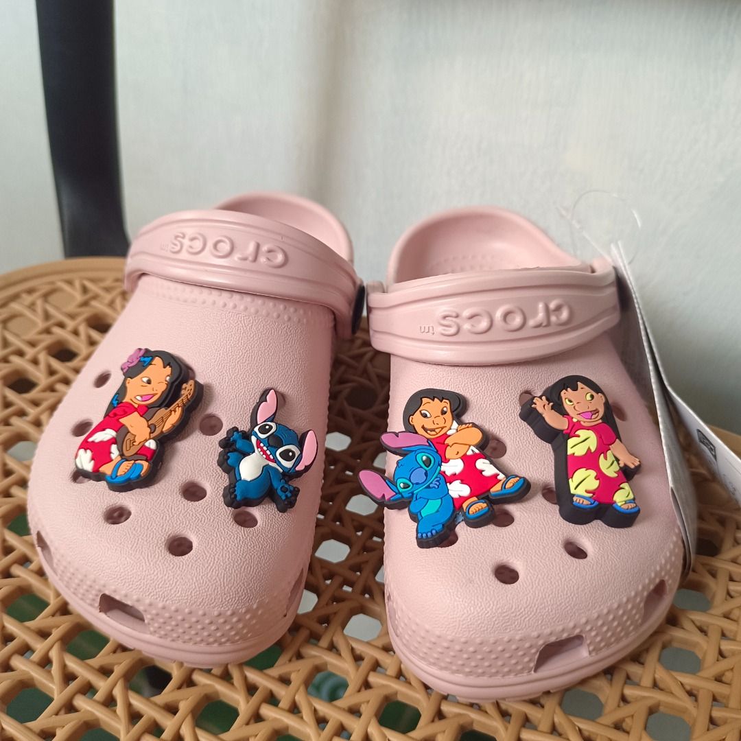 Crocs Lilo & Stitch Pink Clogs with Jibbitz Charms (Category: Babies & Kids Fashion) located in Caloocan City. Submitted by zizomama0509601 (Listing ID 1468390458, Image 3). Description: - Brand new pink Crocs with tags still attached - Decorated with adorable Lilo and Stitch Jibbitz charms - Slip-on design featuring pivoting heel straps for a secure fit - Fun Disney theme on both clogs - Perfect gift for Disney fans and Crocs lovers.