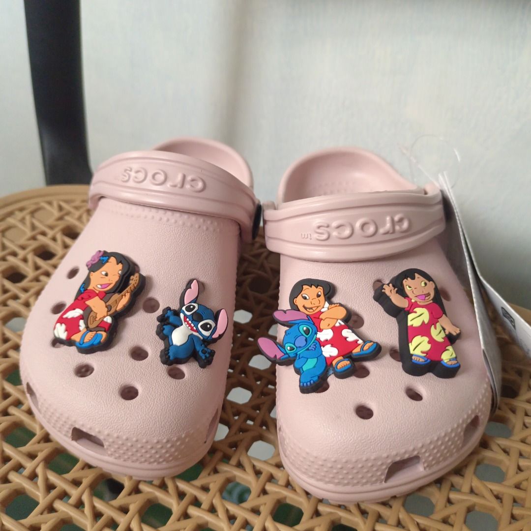 Crocs Lilo & Stitch Pink Clogs with Jibbitz Charms (Category: Babies & Kids Fashion) located in Caloocan City. Submitted by zizomama0509601 (Listing ID 1468390458, Image 1). Description: - Brand new pink Crocs with tags still attached - Decorated with adorable Lilo and Stitch Jibbitz charms - Slip-on design featuring pivoting heel straps for a secure fit - Fun Disney theme on both clogs - Perfect gift for Disney fans and Crocs lovers.