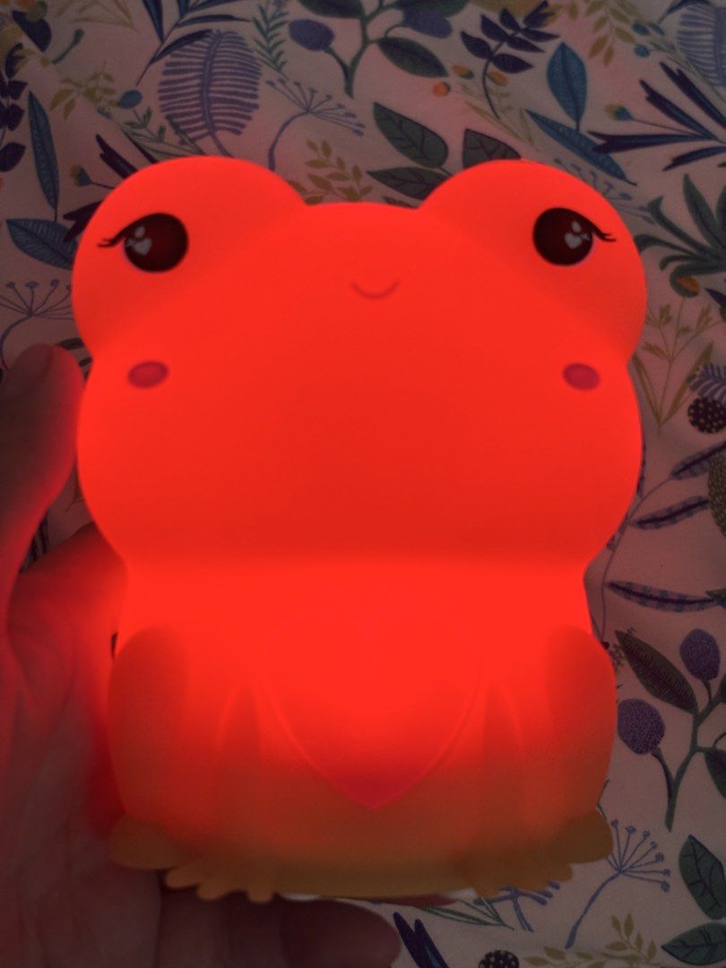 Cute frog silicone night light with color changing LED (Category: Lighting) located in Antipolo. Submitted by annesmarket (Listing ID 1468358705, Image 2). Description: - Adorable frog night light made from soft, touchable silicone - Features sweet sleeping eyes and a cute pink heart on the belly - Glows in multiple vibrant colors (green, red, yellow, and more) - Convenient battery-operated design for easy placement anywhere - Charming decor piec