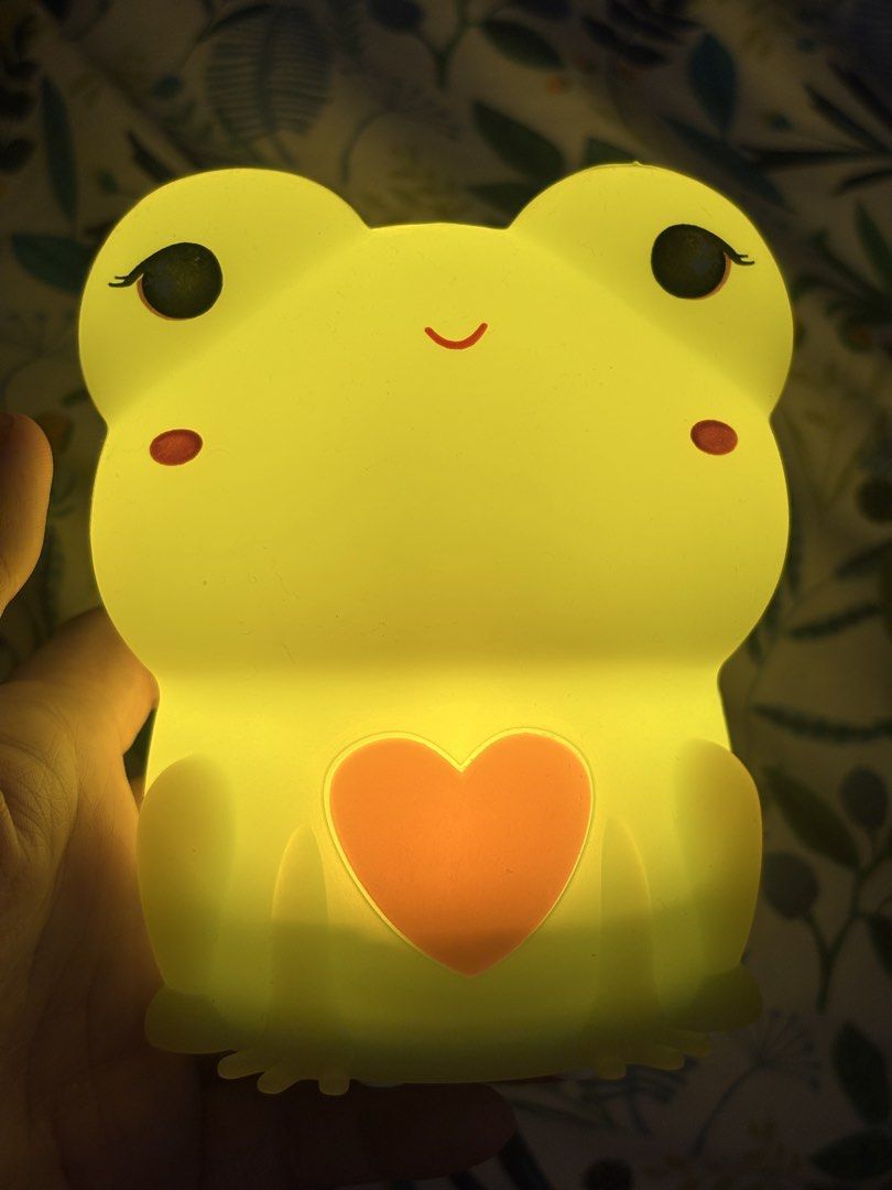 Cute frog silicone night light with color changing LED (Category: Lighting) located in Antipolo. Submitted by annesmarket (Listing ID 1468358705, Image 3). Description: - Adorable frog night light made from soft, touchable silicone - Features sweet sleeping eyes and a cute pink heart on the belly - Glows in multiple vibrant colors (green, red, yellow, and more) - Convenient battery-operated design for easy placement anywhere - Charming decor piec