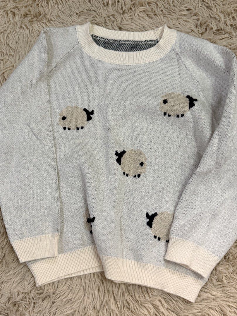 Cute Grey Sheep Print Knit Sweater (Category: Babies & Kids Fashion) located in Quezon City. Submitted by adagavin (Listing ID 1468327354, Image 1). Description: - Design: Cute all-over sheep pattern in grey - Details: Cream ribbed collar, cuffs, and hem - Fit: Relaxed long-sleeve fit - Material: Soft and cozy fabric for chilly days - Styling: Versatile, easy to match with jeans or skirts.