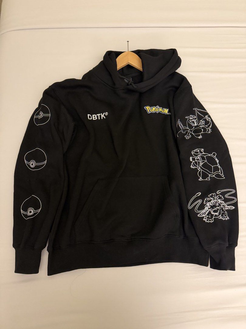DBTK x Pokemon Black Hoodie (Category: Coats, Jackets and Outerwear) located in Pasig City. Submitted by nimskee (Listing ID 1468464208, Image 2). Description: •Official DBTK x Pokemon collaboration black pullover hoodie. •Premium heavyweight cotton fleece with cozy kangaroo pocket and drawstring hood. •Fully embroidered Charizard, Blastoise, and Venusaur graphics with Pokedex numbers on the back. •Final evolution line art printed on one sleeve a