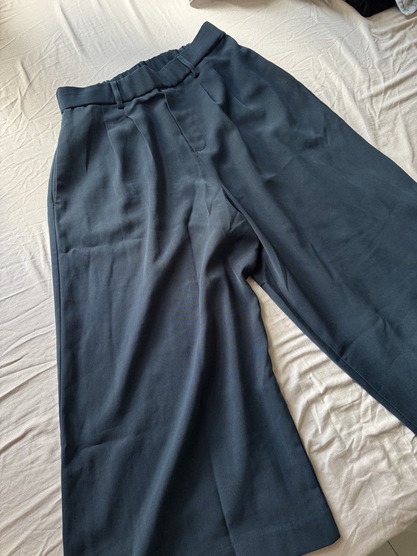 Deep green trouser size 27-30 garterized back (Category: Other Bottoms) located in Mandaluyong City. Submitted by uol77 (Listing ID 1468330337, Image 3). Description: - Color: deep green - Style: Tailored trousers with a pleated front -32 inches in length - Waist: High-waisted with a half elastic band at the back for comfort - Features: Deep side pockets - Fabric: Smooth with a slight drape - Versatility: Ideal for office wear or smart casual dai