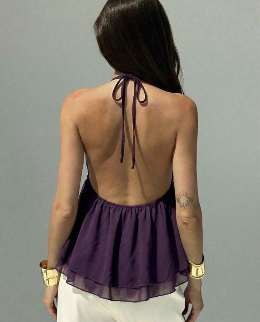 Deep Purple Halter Neck Ruffle Chiffon Top (Category: Sleeveless) located in Quezon City. Submitted by gwy_preloved (Listing ID 1468301766, Image 2). Description: - Color: Deep purple - Material: Lightweight, breathable chiffon - Design: Halter neck with adjustable back tie, front tie closure, and ruffle trim - Back: Open-back design with a layered flared hem - Styling: Perfect for beach trips, vacays, and sunny weather; easy to pair with skirts 