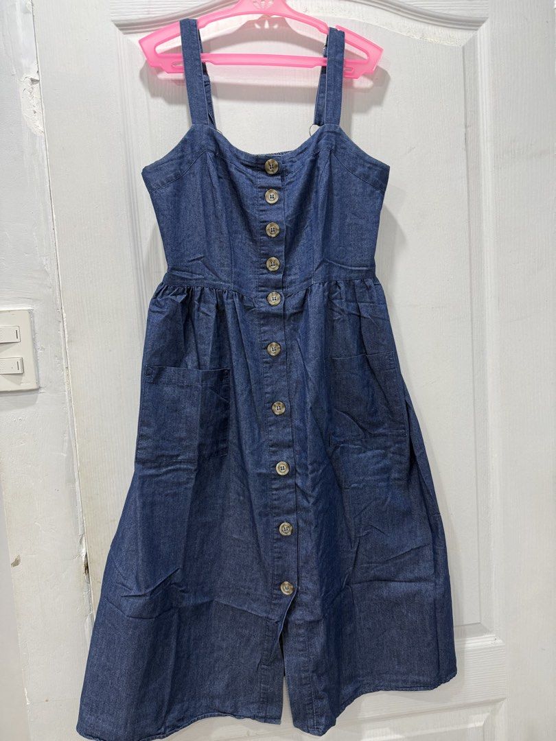Denim Button-Down Midi Dress (Category: Dresses) located in Manila. Submitted by prelov3dbysteph (Listing ID 1468421855, Image 1). Description: - Style: Dark blue wash denim overall dress - Size: Small - Details: Full front button closure and two functional side pockets - Fit: Smocked elastic panel at the back for extra stretch and comfort - Straps: Adjustable metal rings for a customized fit - Condition: Excellent for daily wear, school, or week