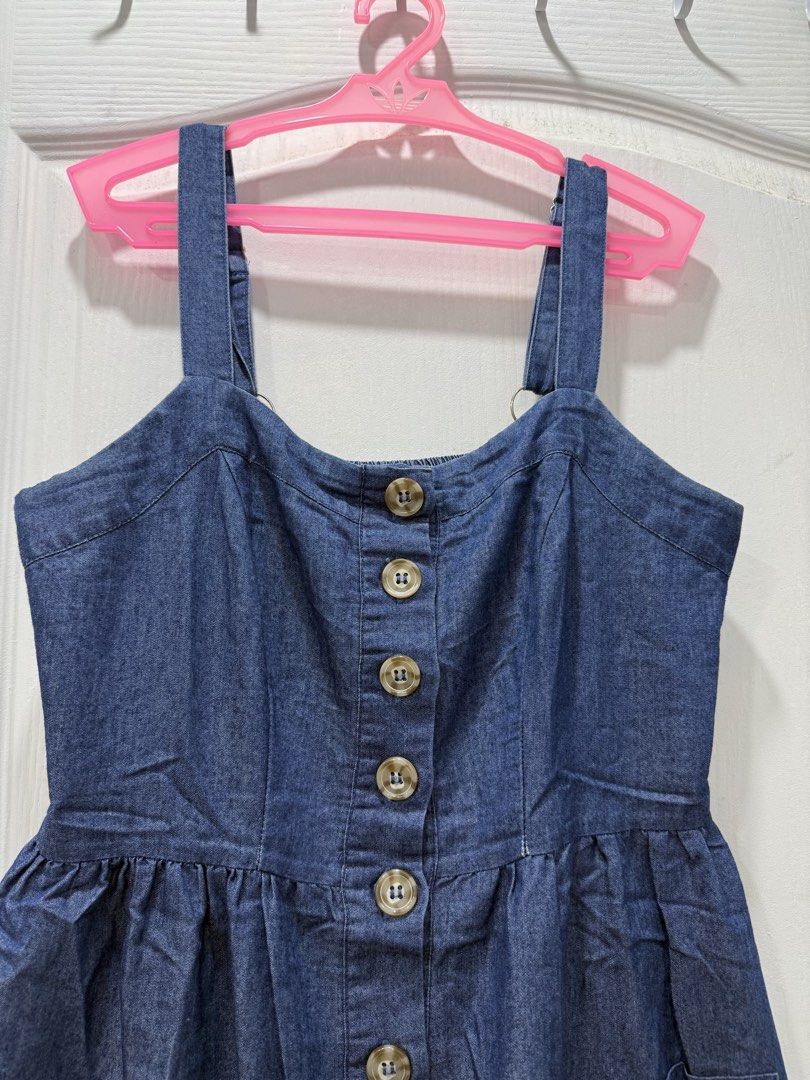 Denim Button-Down Midi Dress (Category: Dresses) located in Manila. Submitted by prelov3dbysteph (Listing ID 1468421855, Image 2). Description: - Style: Dark blue wash denim overall dress - Size: Small - Details: Full front button closure and two functional side pockets - Fit: Smocked elastic panel at the back for extra stretch and comfort - Straps: Adjustable metal rings for a customized fit - Condition: Excellent for daily wear, school, or week