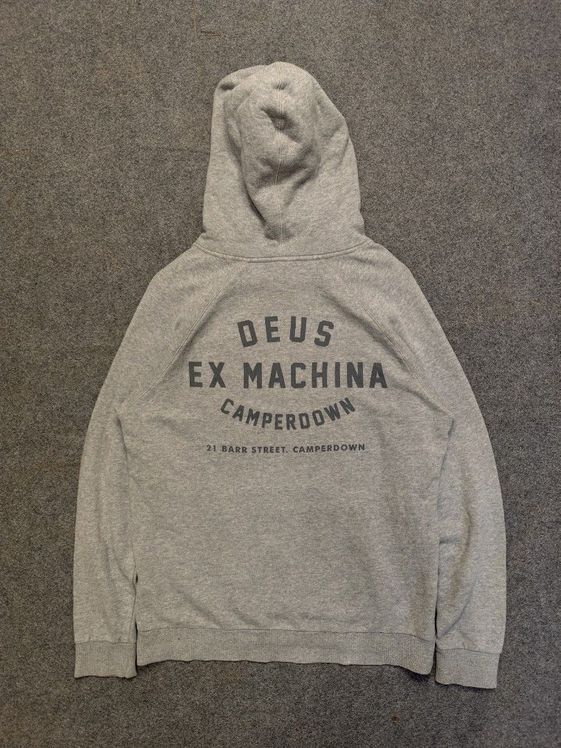 Deus Ex Machina Camperdown Cotton Hoodie (Category: Hoodies) located in Cordova. Submitted by bsb.streetluxvintage.clothing (Listing ID 1468424391, Image 2). Description: - Brand: Deus Ex Machina - Size: Medium - Color: Classic heather grey - Design: Small shield logo on chest; large 'Deus Ex Machina Camperdown' lettering with '21 Barr Street' address on back - Features: Adjustable drawstring hood and front kangaroo pocket - Material: Soft and wa
