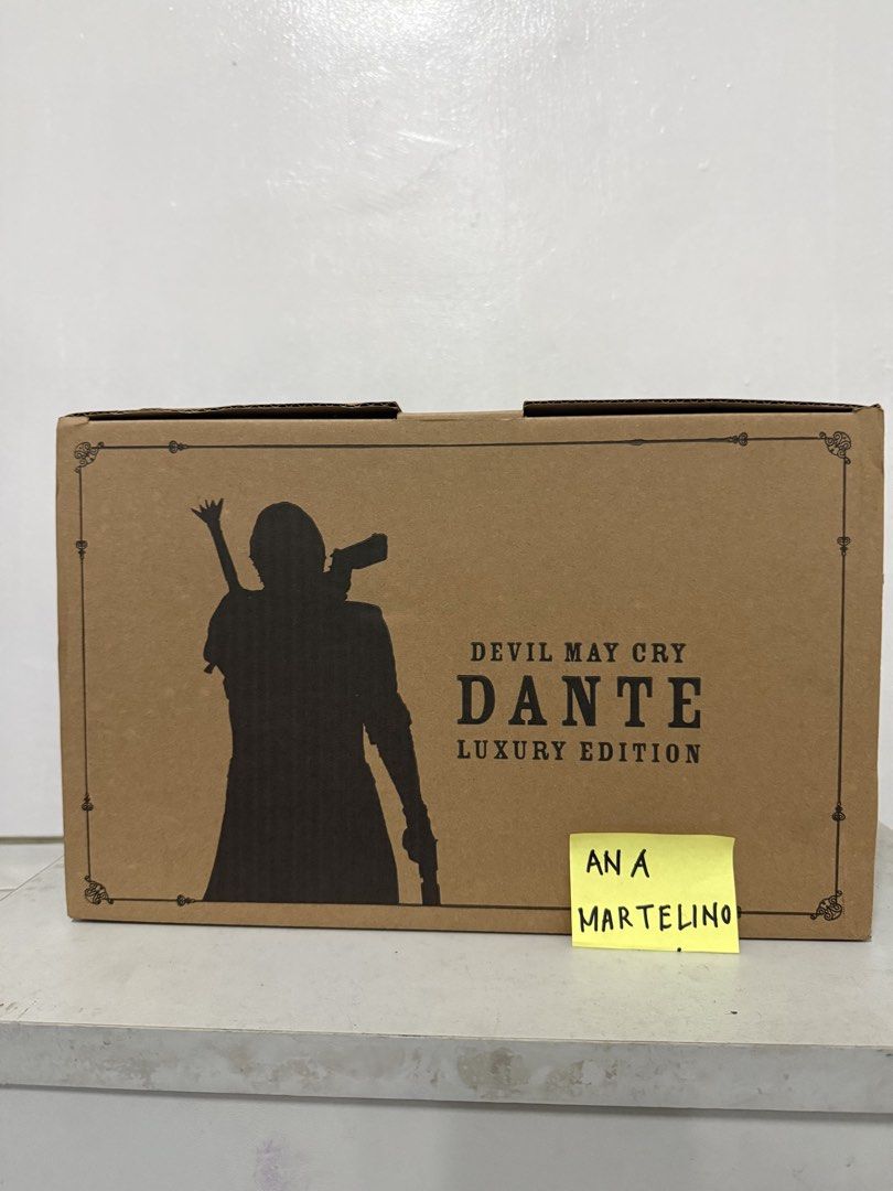 Devil May Cry 5 Dante Luxury Edition 1/6 Action Figure (Category: Figurines & Statues) located in Manila. Submitted by ana_banana011 (Listing ID 1468307615, Image 1). Description: - Brand: Asmus Toys (1/6 scale) - Item: Devil May Cry 5 Dante Luxury Edition - Condition: Brand new in original brown shipper box (unopened) - Special Features: Custom pizza slice and Dante silhouette graphics on box - Included Weapons & Accessories: Rebellion, Devil Sw