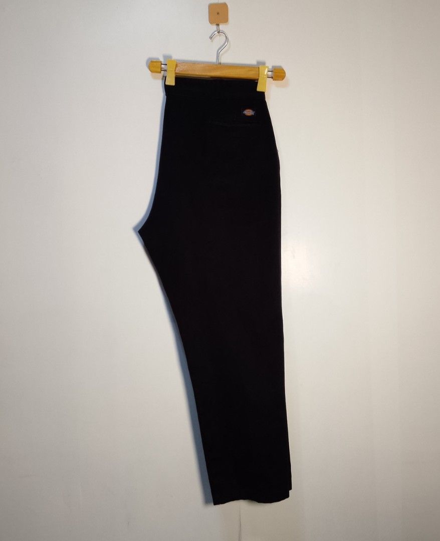 Dickies Black Work Pants (Category: Trousers) located in Manila. Submitted by moisky18 (Listing ID 1468454875, Image 3). Description: - Brand: Dickies - Color: Classic Black - Fit: Straight leg cut - Material: Durable twill fabric - Features: Zip fly with button closure, two back welt pockets with signature woven logo tag - Condition: Tag shows fading from wash and wear, but overall structure remains solid.