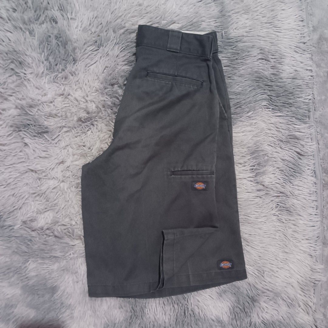 Dickies Charcoal Gray Cargo Work Shorts (Category: Shorts) located in Orani. Submitted by haydenfria26042 (Listing ID 1468323026, Image 1). Description: - Brand: Dickies Size📐 Waist 33 Length 24 Thigh 14 Hem 13 Good condition Ready to use - Color: Dark charcoal gray - Fabric: Durable, sturdy twill - Features: Side utility pocket with classic logo patch, zip fly with hook and bar closure, dual back welt pockets (one with button closure) - Conditi