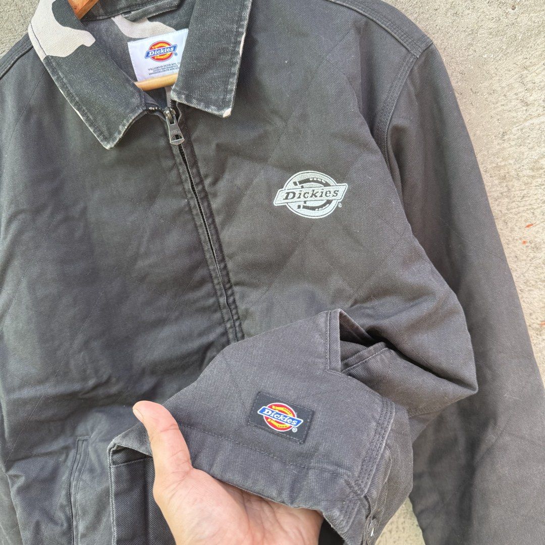 Dickies Quilted Work Jacket With Camo Collar (Category: Coats, Jackets and Outerwear) located in Caloocan City. Submitted by ayogorenia1002 (Listing ID 1468350099, Image 2). Description: - Brand: Dickies - Color: Black canvas with camo pattern on the collar - Lining: Quilted for extra warmth - Details: Embroidered chest logo, small patch on cuff, Williamson-Dickie neck tag - Pockets: Two front welt pockets - Cuffs & Hem: Ribbed for a snug fit - H