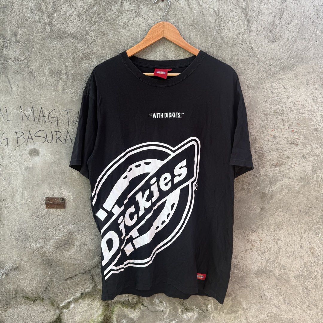 Dickies "With Dickies" Black Graphic Tee Size XL (Category: Tshirts & Polo Shirts ) located in Caloocan City. Submitted by ayogorenia1002 (Listing ID 1468350846, Image 1). Description: - Brand: Dickies - Color: Black - Size: XL (Classic Fit) - Material: 100% Cotton - Design: Large white logo graphic with "WITH DICKIES" text on the lower front - Accents: Red Dickies woven label tags on the collar and sleeve hem - Condition: Brand new / Excellent q