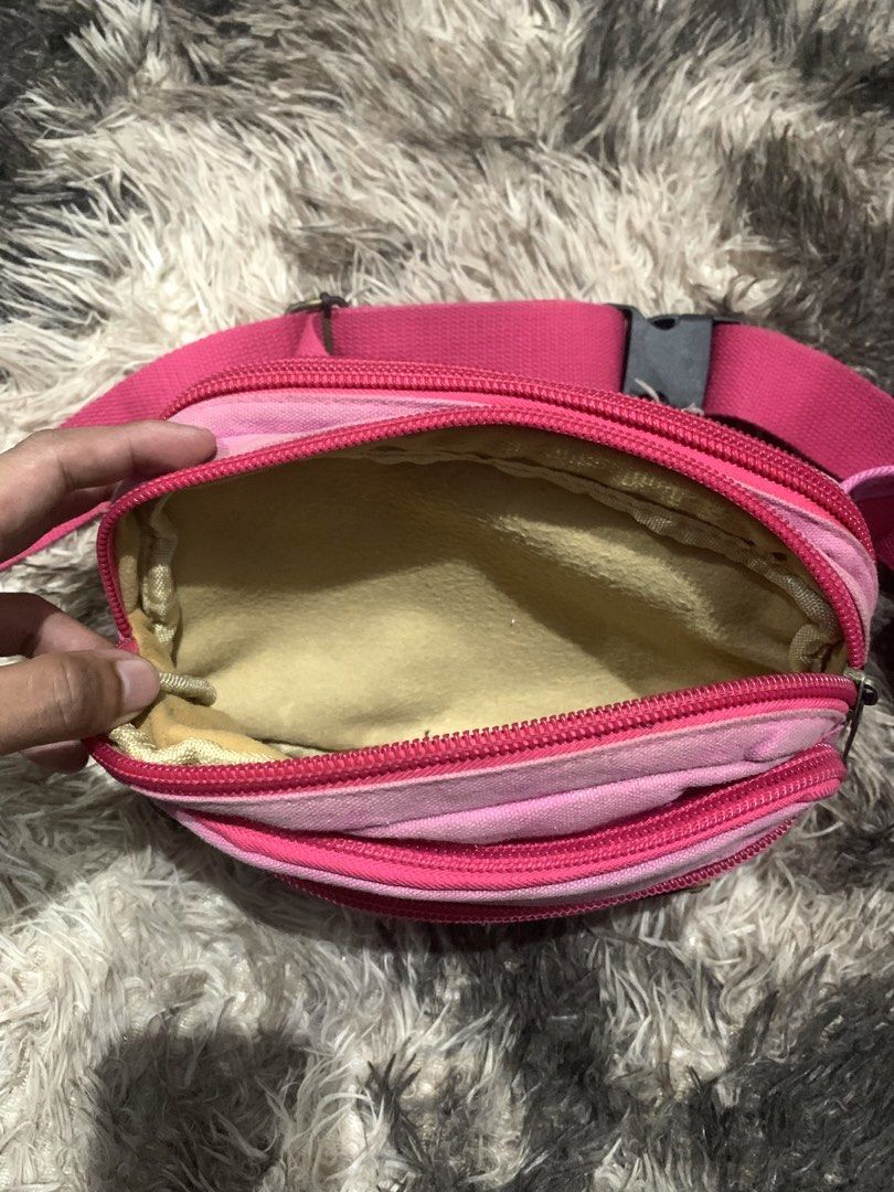 Diesel Pink Canvas Fanny Pack (Category: Belt bags, Clutches and Pouches) located in Manila. Submitted by jay_seller (Listing ID 1468289862, Image 3). Description: - Brand: Diesel - Material: Durable canvas in bright pink - Features: Metal DIESEL logo plaque, multiple zippered compartments, adjustable strap with side-release buckle - Condition: Hardware has vintage patina and minor fabric discoloration near the metal plate.
