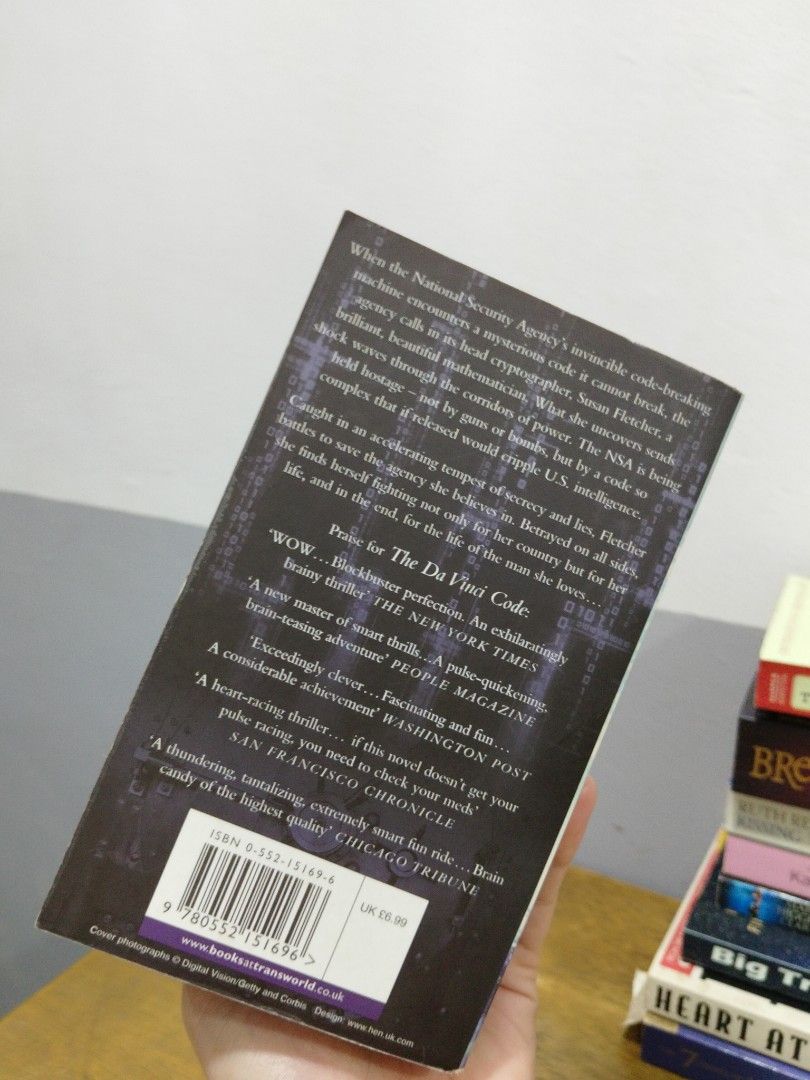 Digital Fortress by Dan Brown Paperback Novel (Category: Storybooks) located in Bocaue. Submitted by wendyiv (Listing ID 1468486250, Image 2). Description: - Title: Digital Fortress by Dan Brown - Genre: Techno-thriller about the NSA and a mysterious code - Format: Standard paperback - Condition: Spine intact, pages clean with no markings, and minor shelf wear on the cover, minor loose pages - Note: Page edges show natural yellowing due to age.