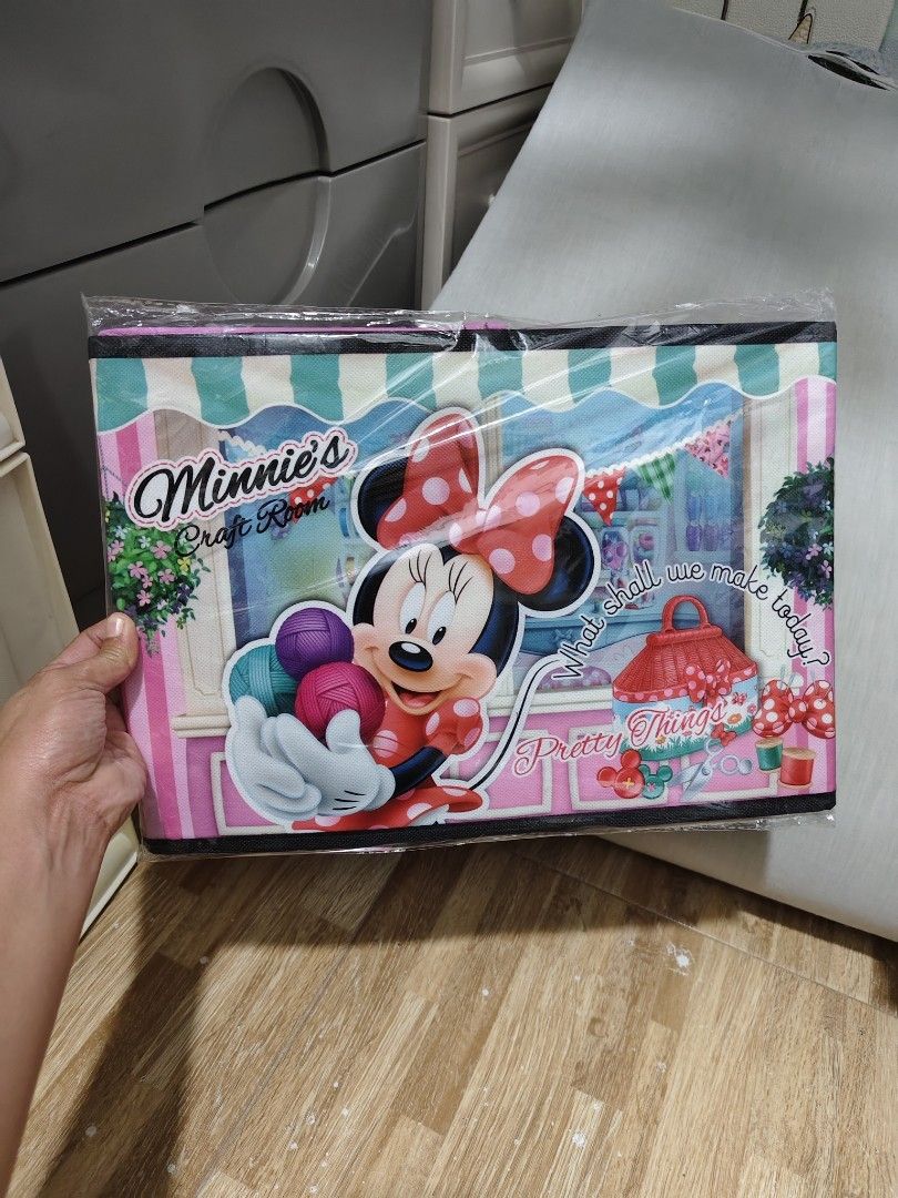 Disney Minnie Mouse Craft Room Storage Box (Category: Storage Boxes & Baskets) located in Makati City. Submitted by abegailbrezuela (Listing ID 1468405233, Image 1). Description: - Authentic Disney Minnie Mouse collapsible storage box - Features an adorable craft room graphic in pink fabric with black trim - Brand new, unused, with tag attached in original plastic wrapping - Dimensions: approx. 38 x 26 x 26 cm - Perfect for organizing toys, cloth