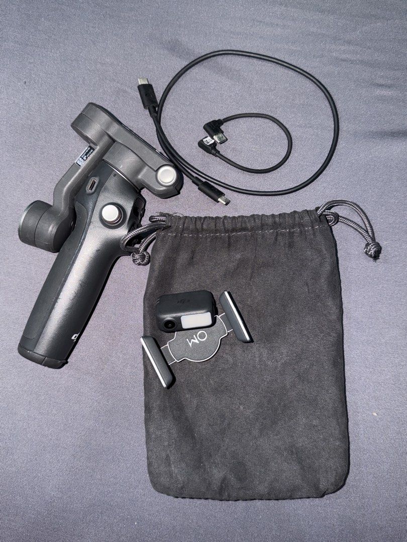 DJI Osmo Mobile 7P Smartphone Stabilizer Gimbal (Category: Gimbals & Stabilizers ) located in Quezon City. Submitted by jpfinds (Listing ID 1468436305, Image 2). Description: DJI Osmo Mobile 7P smartphone stabilizer. Includes original box, pouch, magnetic phone clamp, built-in fill light/tracker module, and charging cables. Everything powers on and functions properly. Minimal wear on the handle grip, screen lights up clearly. Great setup for smoo