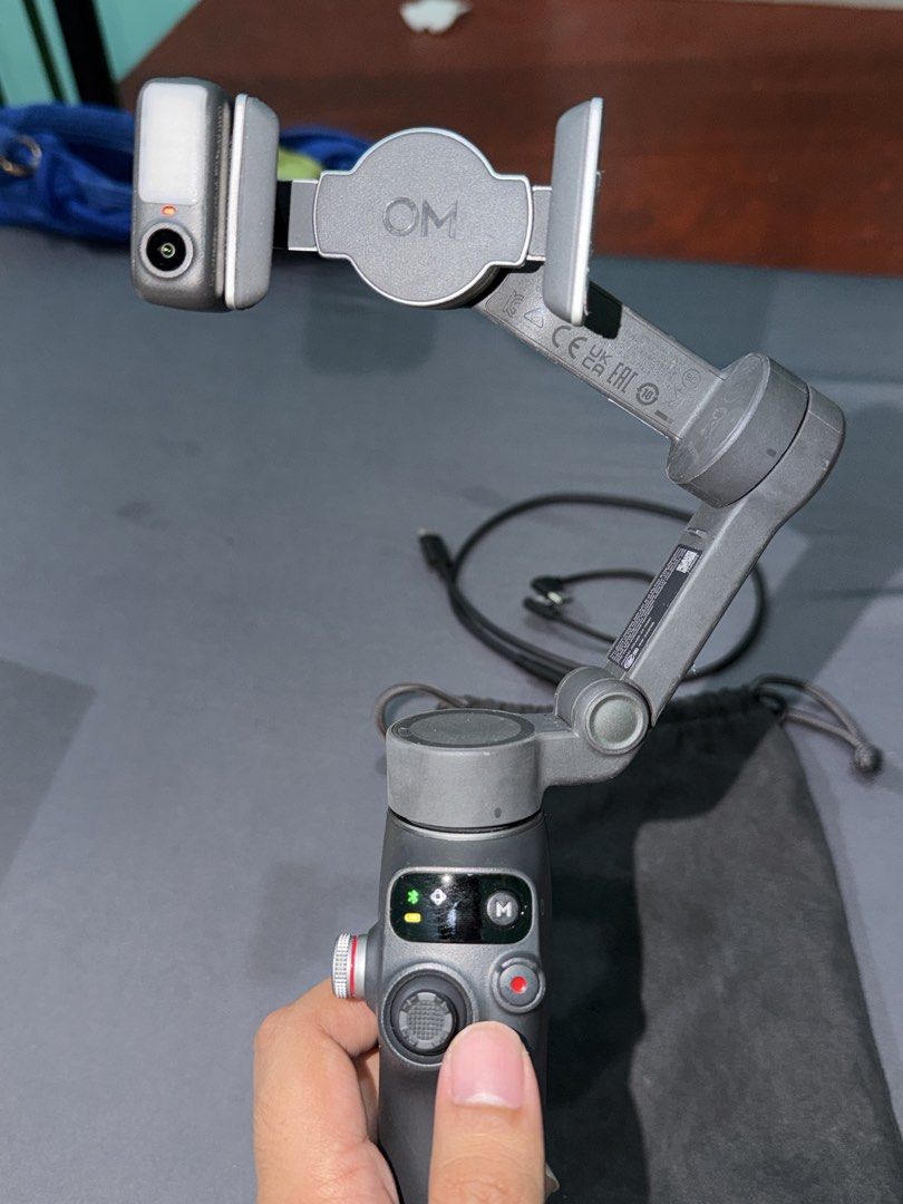 DJI Osmo Mobile 7P Smartphone Stabilizer Gimbal (Category: Gimbals & Stabilizers ) located in Quezon City. Submitted by jpfinds (Listing ID 1468436305, Image 3). Description: DJI Osmo Mobile 7P smartphone stabilizer. Includes original box, pouch, magnetic phone clamp, built-in fill light/tracker module, and charging cables. Everything powers on and functions properly. Minimal wear on the handle grip, screen lights up clearly. Great setup for smoo