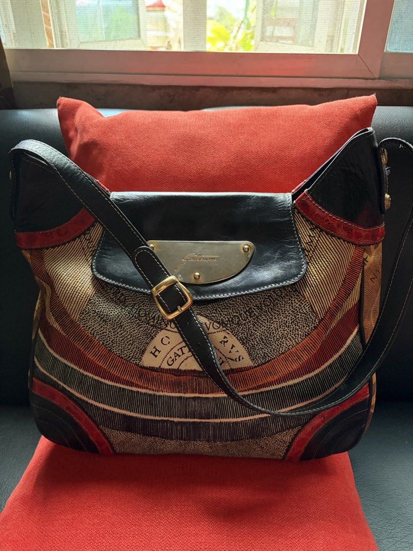 DKNY Black Structured Handbag with Gold Hardware (Category: Luxury Bags & Wallets) located in Caloocan City. Submitted by wildstar.f2ca8a (Listing ID 1468499347, Image 2). Description: Classic black handbag from DKNY. Sturdy top handles, gold-tone hardware, and a secure lock closure on the front flap. Includes dual zippered pockets below the flap for easy access. Hanging logo charm attached to the ring. Clean fabric interior with plenty of room f