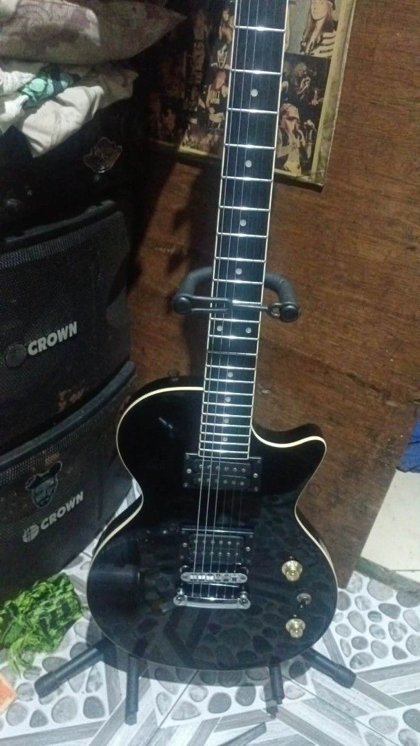 Donner Electric Guitar Black Single Cutaway (Category: Musical Instruments) located in Manila. Submitted by cosmicdeer.c5ba23 (Listing ID 1468414292, Image 1). Description: - Brand/Model: Donner electric guitar in classic black finish - Body & Pickups: Single cutaway shape loaded with dual humbucker pickups - Hardware & Controls: Chrome hardware, volume and tone knobs, and pickup selector switch - Neck & Fretboard: Standard fretboard featuring cl