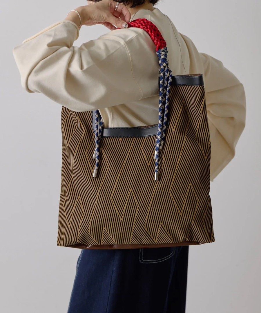 ear PAPILLONNER MTA Mix Tote Bag (Category: Tote Bags) located in Pasig City. Submitted by cosmicjuice08 (Listing ID 1468415723, Image 2). Description: ear PAPILLONNER MTA Mix Tote Bag 🤎 Japanese brand ear PAPILLONNER - Reversible 2-in-1 design: Glossy brown on one side, black and beige geometric zig-zag on the other - Unique rope handles with red accents and metal tips - Spacious enough for A4 documents 📏 Approx. 43.5 cm (H) × 41 cm (W) 🇯🇵 B