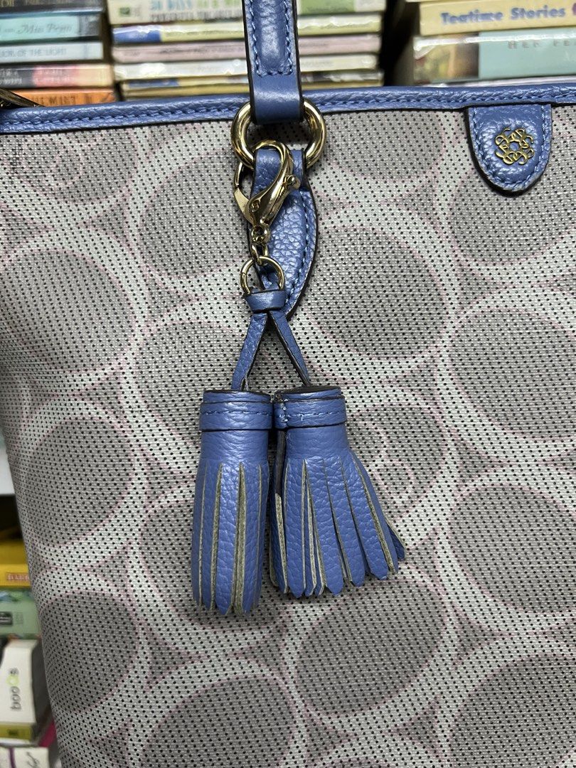 Elegance Blue and Gray Tote Bag (Category: Tote Bags) located in Manila. Submitted by apoltree (Listing ID 1468440096, Image 2). Description: - Brand: Elegance - Color: Blue and gray with blue leather trim - Design: Perforated circular pattern across the body with matching double tassels - Hardware: Gold-tone - Closure: Top zipper - Pockets: Exterior zipper pocket on the back - Condition: Clean interior and well-maintained structured shape -with 