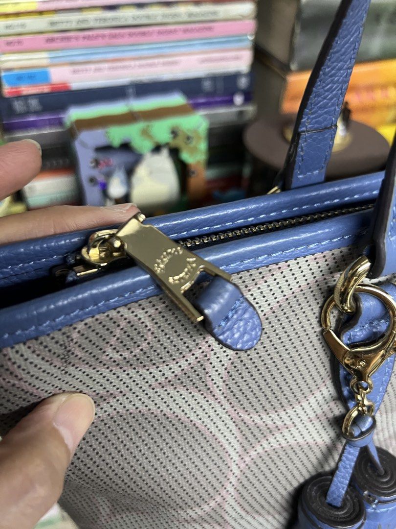 Elegance Blue and Gray Tote Bag (Category: Tote Bags) located in Manila. Submitted by apoltree (Listing ID 1468440096, Image 3). Description: - Brand: Elegance - Color: Blue and gray with blue leather trim - Design: Perforated circular pattern across the body with matching double tassels - Hardware: Gold-tone - Closure: Top zipper - Pockets: Exterior zipper pocket on the back - Condition: Clean interior and well-maintained structured shape -with 