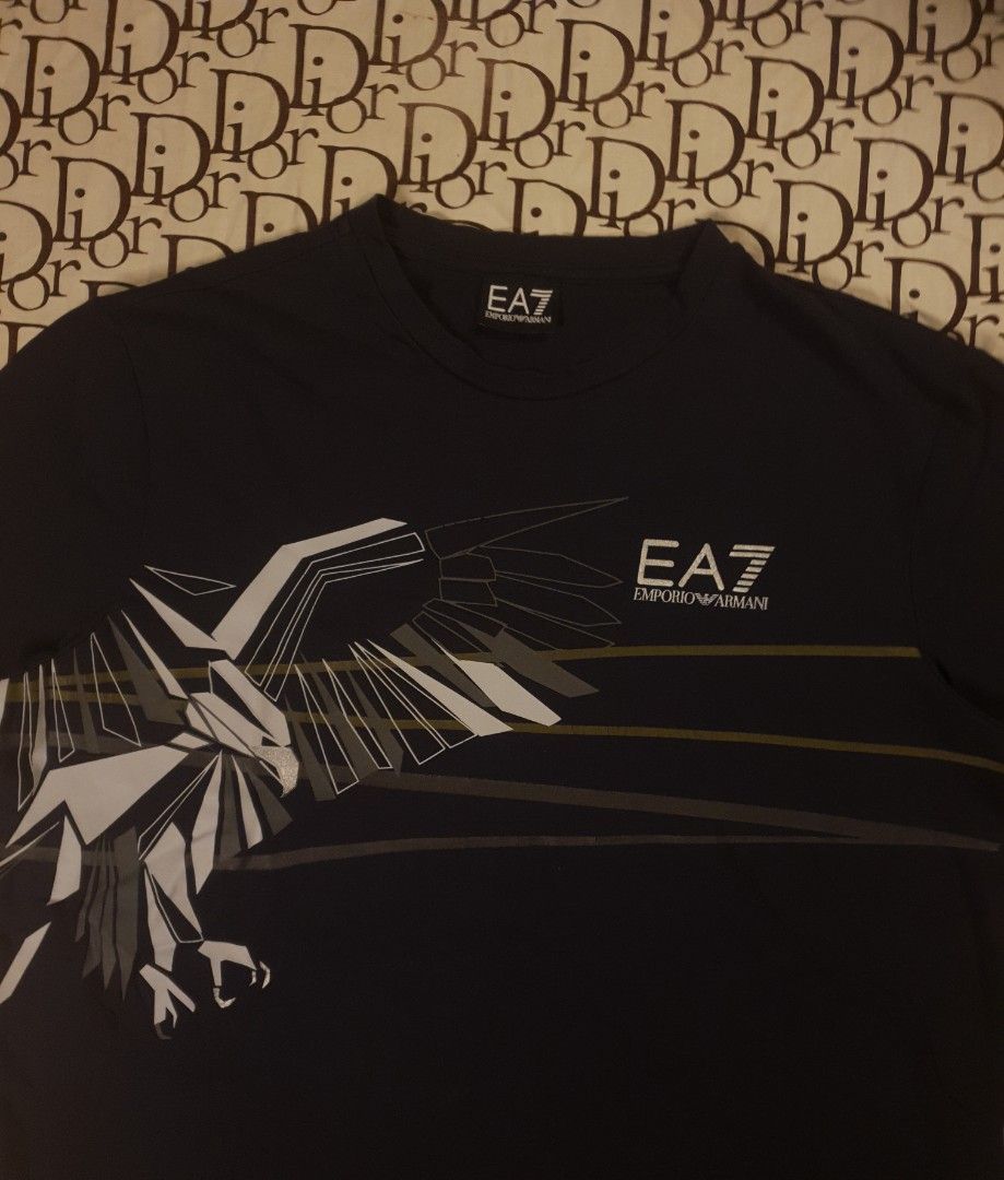 Emporio Armani (Category: Tshirts & Polo Shirts ) located in San Fernando. Submitted by retro.district. (Listing ID 1468464953, Image 2). Description: - Emporio Armani eagle design - Size: Large - Condition: Excellent - No issue.