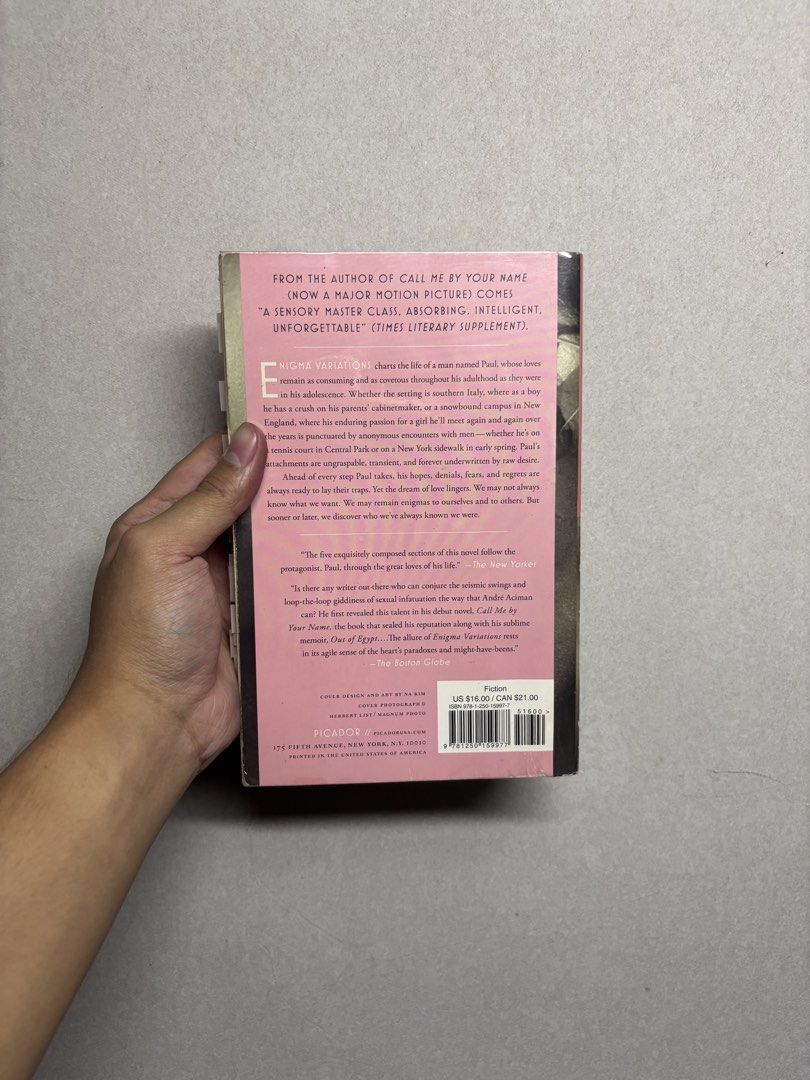 Enigma Variations by André Aciman (Category: Storybooks) located in Cabuyao City. Submitted by john.sellsthings (Listing ID 1468393869, Image 3). Description: - Title: Enigma Variations by André Aciman - Publisher/Format: Picador paperback with pink and grey cover art - Condition: Pages are slightly yellowed with age, has writing on title page, spine slightly cracked, tabs will be removed - Bonus: From the bestselling author of Call Me by Your Na