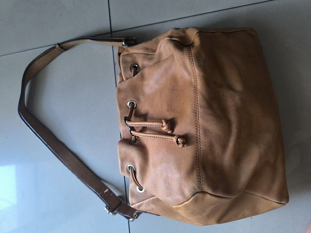 ESPRIT leather 3-compartment drawstring bag (Category: Shoulder Bags) located in Manila. Submitted by lianlim.mail (Listing ID 1468343459, Image 2). Description: ESPRIT leather 3-compartment drawstring bag drawstring front and back (separate compartments) and then a zip middle compartment lightweight soft leather signs of use/fading/scuffs. overall still looks good. clean interiors.