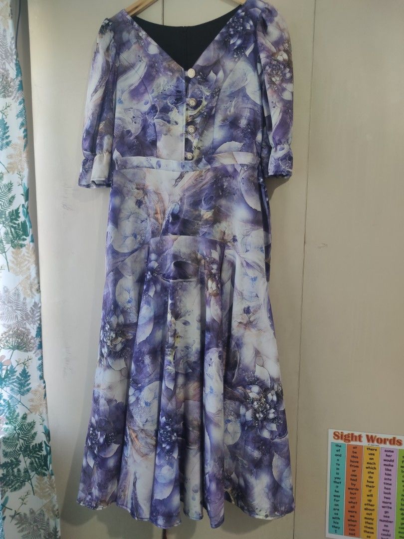 Everyday Hermana Edwina Dress (Category: Dresses) located in Bacolod City. Submitted by leighleigh17 (Listing ID 1468292806, Image 2). Description: - Brand: Everyday Hermana (Edwina dress) - Pattern/Color: Printed abstract violet - Style: Midi length, V-neckline with decorative gold buttons, fitted waist, flared skirt, and puff sleeves with gathered cuffs - Fabric: Lightweight with a smooth finish - Condition:like new b35 w30 L48 no pockets free 