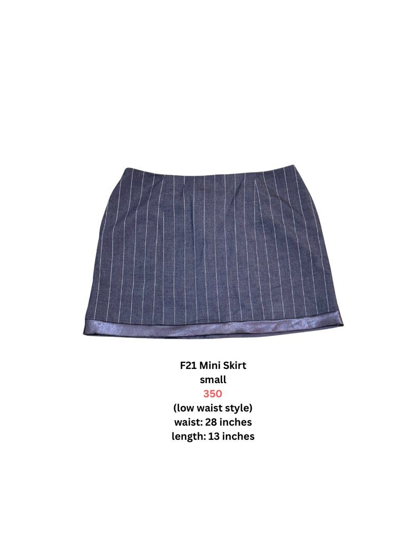 F21 Mini Skirt Small Low Waist (Category: Skirts) located in Angeles City. Submitted by vega.rachel (Listing ID 1468284959, Image 1). Description: - Brand: Forever 21 (F21) - Style: Low-waist mini skirt in dark denim with thin white pinstripes - Accent: Shiny metallic purple trim along the bottom hem - Size: Small - Measurements: 28-inch waist, 13-inch length - Condition: Excellent, easy to style for casual outings or parties.