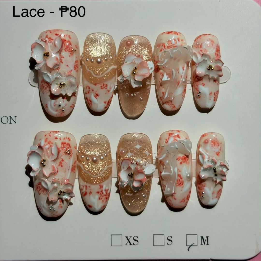 Fairy Press-on Nails Lace Design Size M Cateye (Category: Hands & Nails) located in Manila. Submitted by takoyakizzz (Listing ID 1468420888, Image 1). Description: - Handmade press-on nail set in a chic lace and floral theme - Size M, includes 10 pieces per set - Features detailed 3D flower decorations, lovely shimmer effects, and elegant gold accents - Budget-friendly at only ₱80 per set - Quick and easy application for a salon-look without the 
