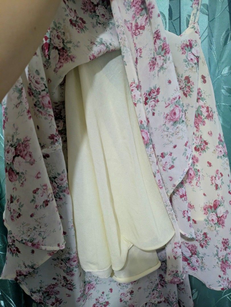Fairycore Whimsy Floral chiffon top (Category: Sleeveless) located in Bocaue. Submitted by _agentorange (Listing ID 1468361441, Image 2). Description: - Design: Cream background with all-over pink and red rose pattern - Fit & Style: Spaghetti straps, V-neckline, and a flowy asymmetric hem with great movement - Comfort: Fully lined (not see-through) and made of lightweight material ideal for warmer weather - Versatility: Easy to style with your fa