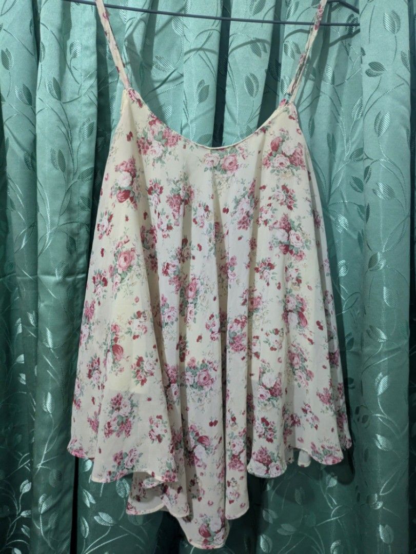 Fairycore Whimsy Floral chiffon top (Category: Sleeveless) located in Bocaue. Submitted by _agentorange (Listing ID 1468361441, Image 1). Description: - Design: Cream background with all-over pink and red rose pattern - Fit & Style: Spaghetti straps, V-neckline, and a flowy asymmetric hem with great movement - Comfort: Fully lined (not see-through) and made of lightweight material ideal for warmer weather - Versatility: Easy to style with your fa